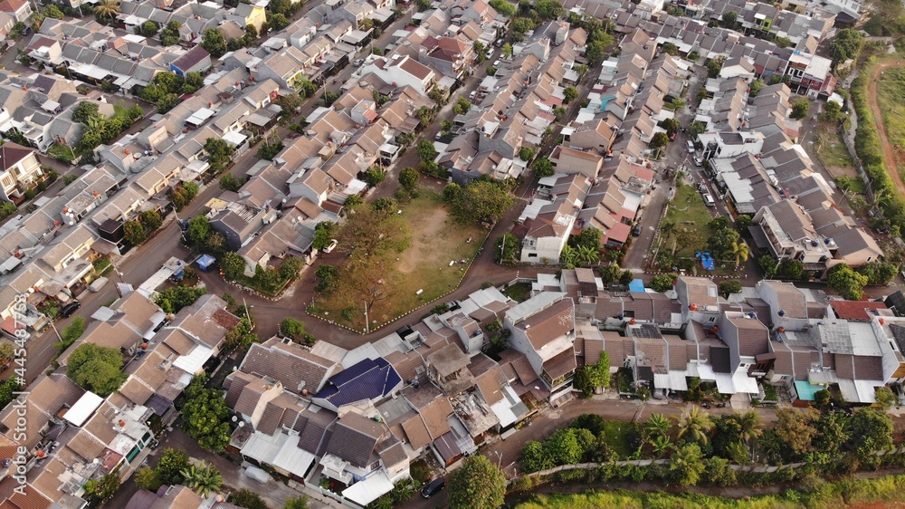 Aerial drone view of one residential at depok city, indonesia, with green field and many houses