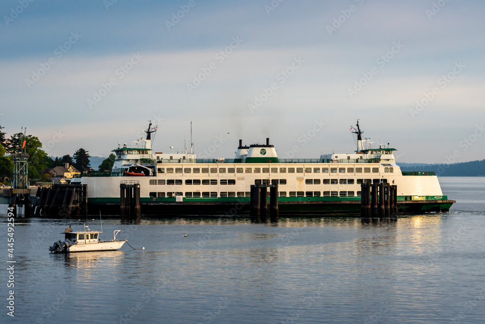 A Washington State Ferry is docked at an island in Puget Sound of the Pacific Northwest. A Washington State Ferry is docked at an island in Puget Sound of the Pacific Northwest.