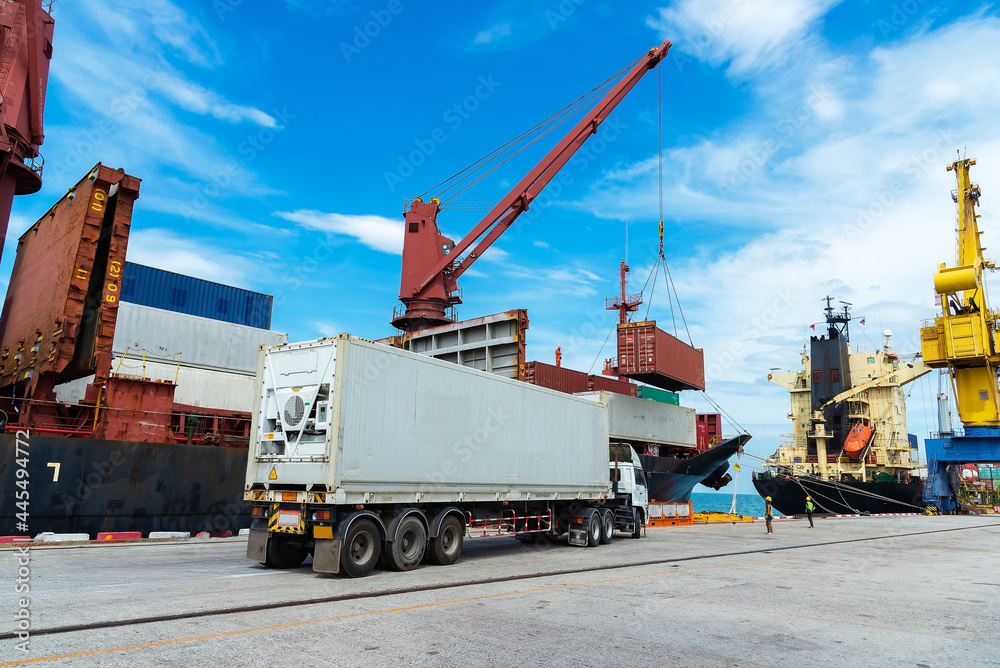 container ship commercial vessel alongside in port for loading and discharging containers services in maritime transports in World wide logistics