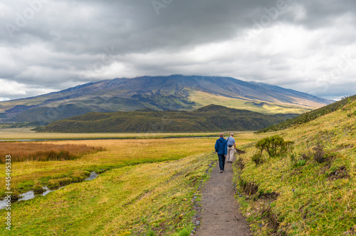 Tourists walking the Limpiopungo lagoon hike, Cotopaxi volcano national park, Quito, Ecuador.