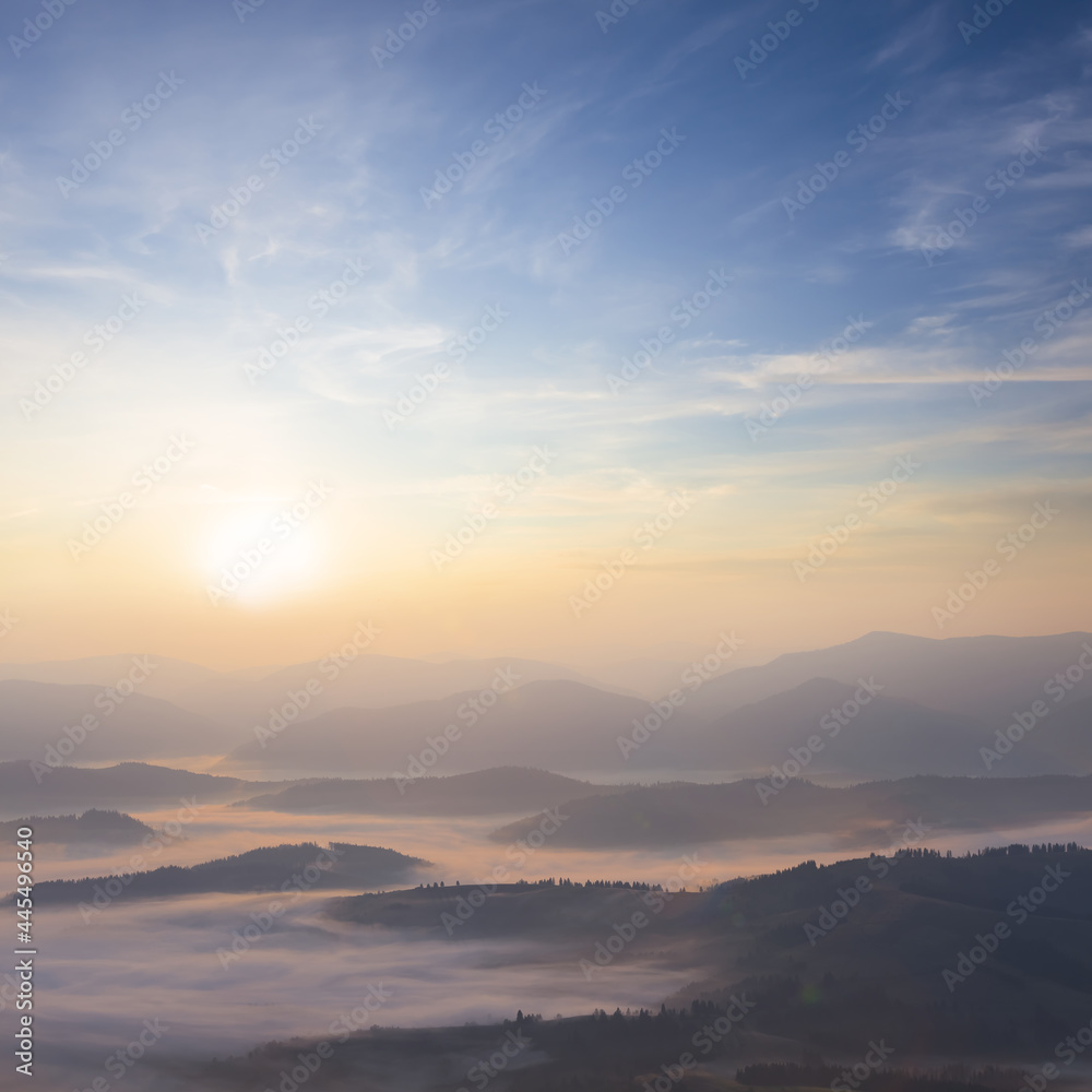mountain valley in blue mist at the early morning, natural travel background