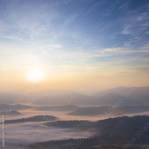mountain valley in blue mist at the early morning, natural travel background