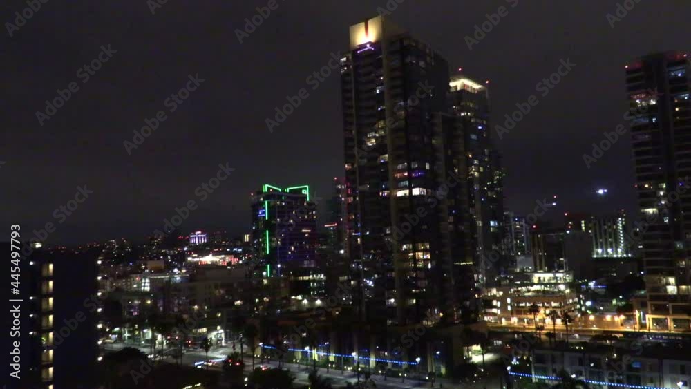 Night Time view of a Plane Landing over San Diego California with the City Light Blinking and Shining in the Background Night Time view of a Plane Landing over San Diego California with the City Light Blinking and Shining in the Background