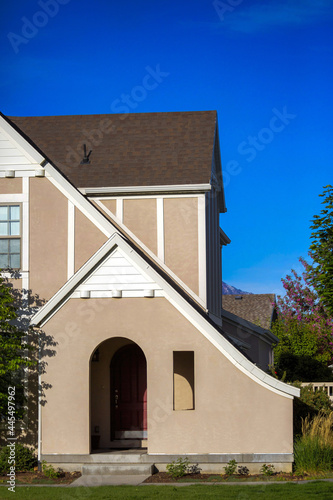 Vertical shot of a detached house on a sunny, cloudy day photo