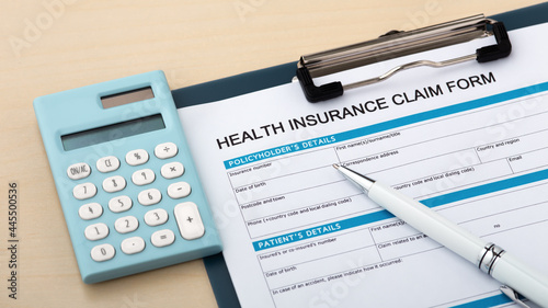 Health insurance claim form with calculator photo