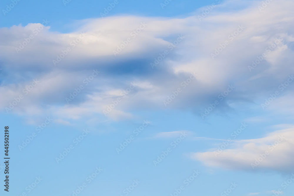 Background of blue sky with white and pink clouds in sunset