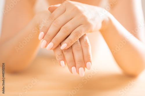Hand Skin Care. Closeup soft Female Hands With Natural Manicure Nails. Close Up Of Woman s Hand Touching Her Soft Silky Healthy Skin. woman hands applying moisturizing cream to her skin