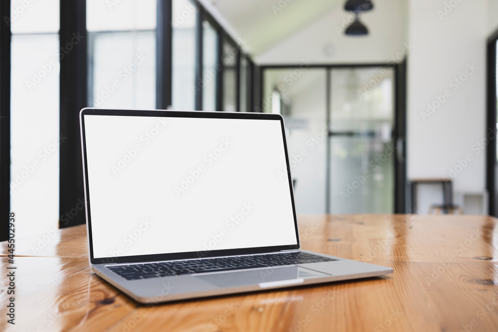 Computer laptop with white display on wooden table. Computer laptop with white display on wooden table.