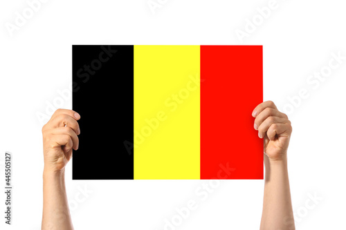 Human hands holding Belgian flag on white background