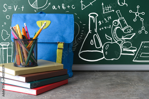 Books with schoolbag and st...