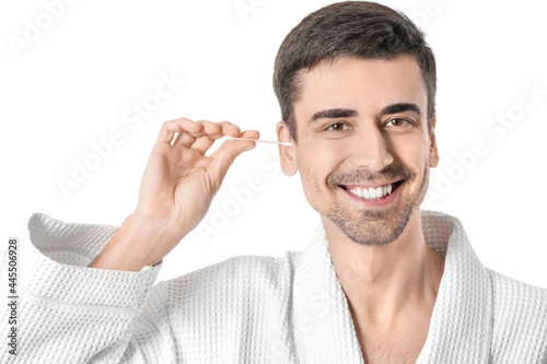 Young man cleaning ears wit...