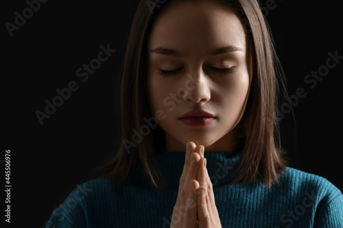 Religious young woman prayi...