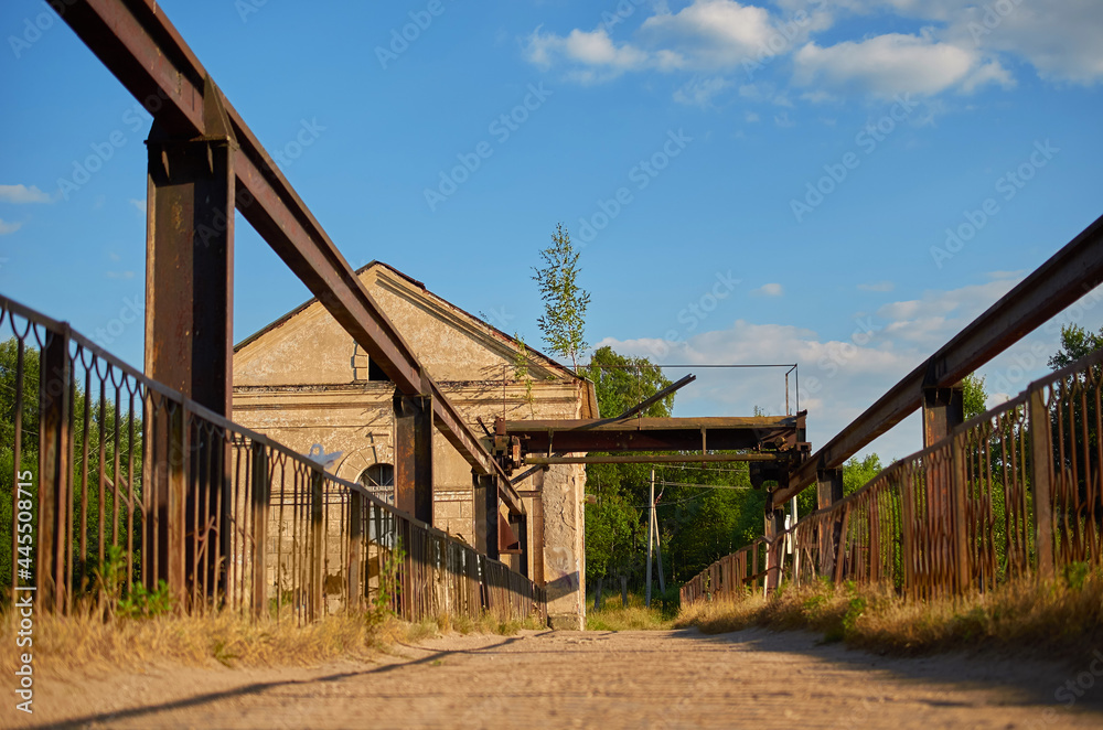 Pedestrian bridge across the river to the abandoned hydroelectric power station Pedestrian bridge across the river to the abandoned hydroelectric power station