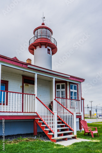 View on Matane's lighthouse, a red and white lighthouse located on the Northern shore of the Gaspesie peninsula, in the Bas Saint Laurent administrative region (Quebec, Canada) photo
