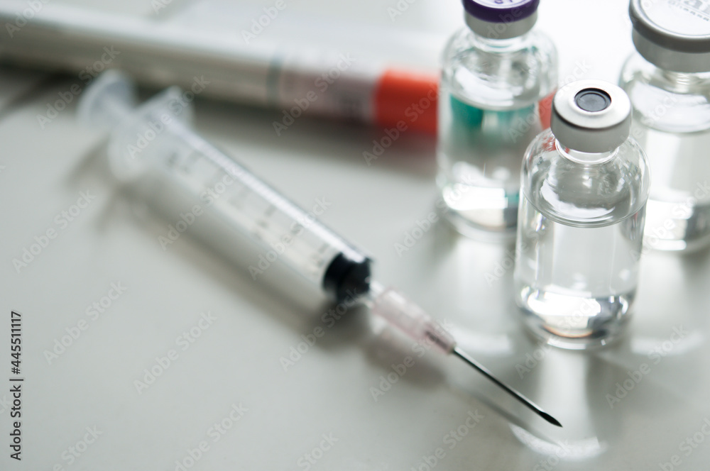 Selective Focus of Syringe and Medicine in vial , ready for vaccine injection , Cancer Treatment , Pain Treatment and can also be abused for an illegal use, healthcare and medical concept vaccination. Selective Focus of Syringe and Medicine in vial , ready for vaccine injection , Cancer Treatment , Pain Treatment and can also be abused for an illegal use, healthcare and medical concept vaccination.