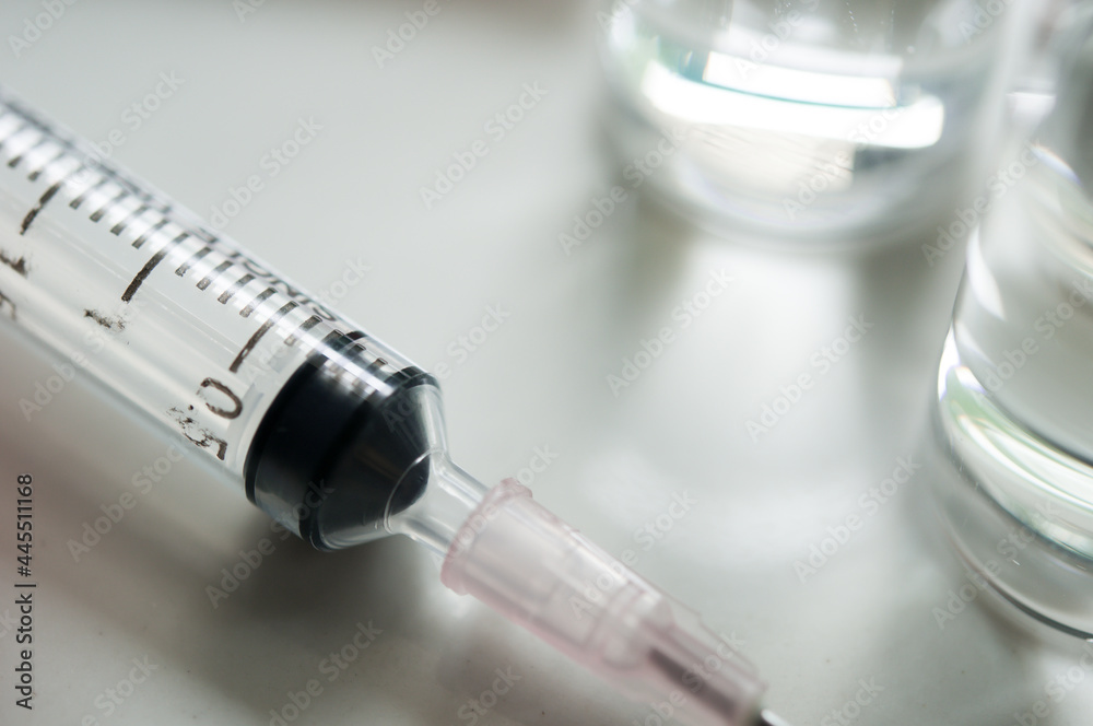 Selective Focus of Syringe and Medicine in vial , ready for vaccine injection , Cancer Treatment , Pain Treatment and can also be abused for an illegal use, healthcare and medical concept vaccination. Selective Focus of Syringe and Medicine in vial , ready for vaccine injection , Cancer Treatment , Pain Treatment and can also be abused for an illegal use, healthcare and medical concept vaccination.