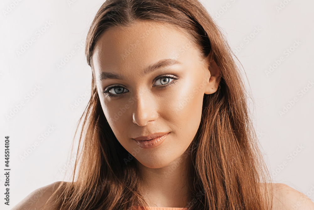 Beautiful young girl smiling and posing looking at the camera on a white isolated background. Positive brunette woman. Kind look. Beauty face Beautiful young girl smiling and posing looking at the camera on a white isolated background. Positive brunette woman. Kind look. Beauty face