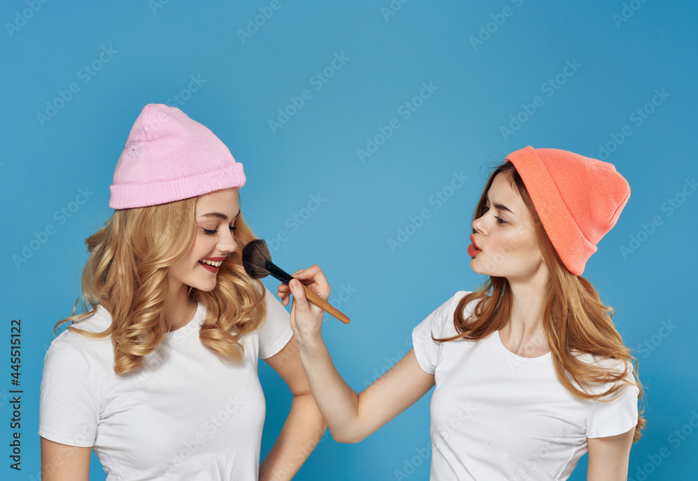 two girlfriends in white t-shirts makeup Friendship help with cosmetics two girlfriends in white t-shirts makeup Friendship help with cosmetics