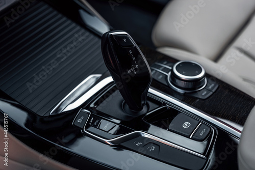 Cockpit interior cabin details. Automatic gear shifter in a modern expensive car. Car interior with close-up of automatic transmission. © Oleksandr