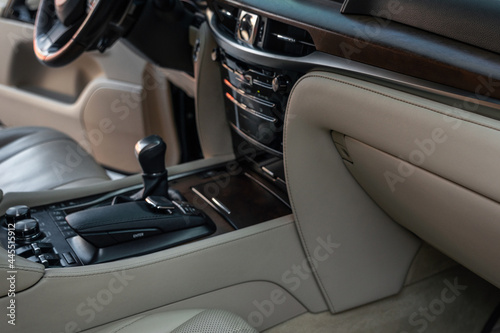 Luxury car Interior - steering wheel, shift lever and dashboard. Interior detail of new modern car