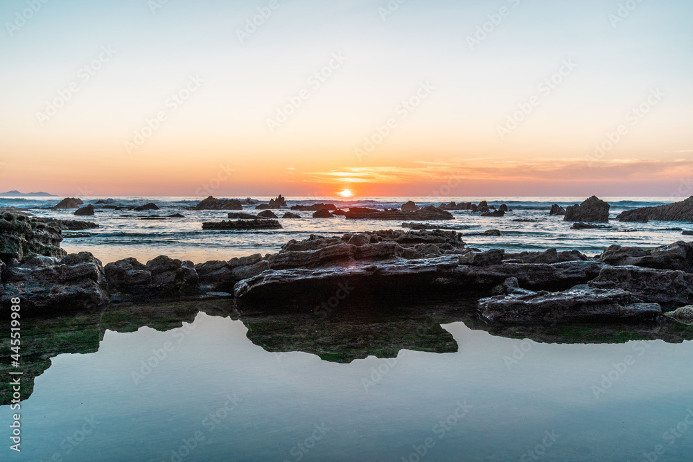 sunset over the sea with rocks