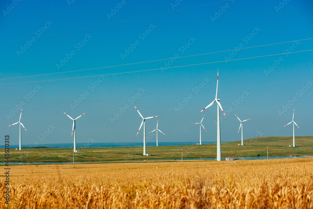 Wind electricity generator in summer fields, power plant, wind efficiency Wind electricity generator in summer fields, power plant, wind efficiency