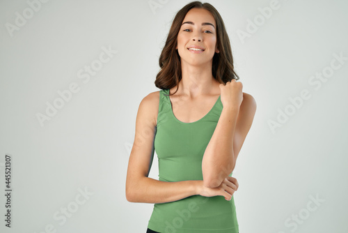 pretty brunette wearing green tank top fashion hairstyle smile cropped view