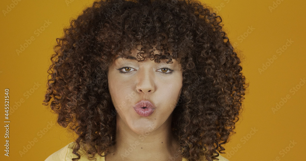 Beautiful brunette model on yellow. Curly hair. Brazilian young woman. Beautiful brunette model on yellow. Curly hair. Brazilian young woman.