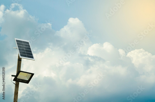 Street lighting pole with photovoltaic panel and LED lamp lights.