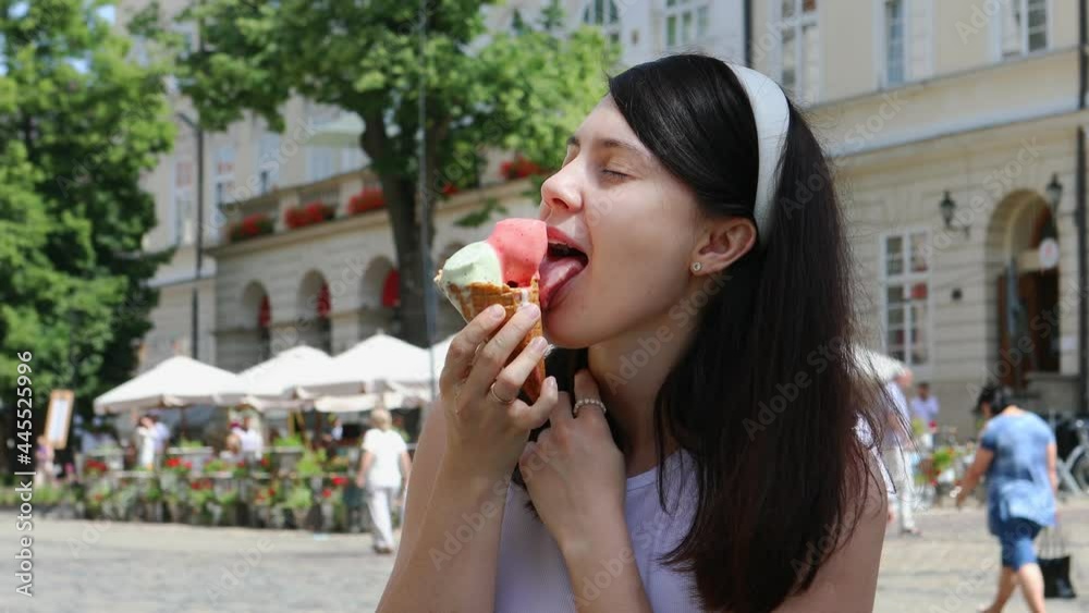 smiling woman eating ice cream at hot day smiling woman eating ice cream at hot day