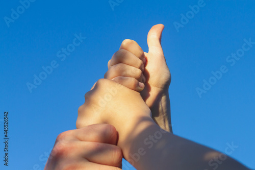 People put their hands on each other as a sign of reciprocity and command photo