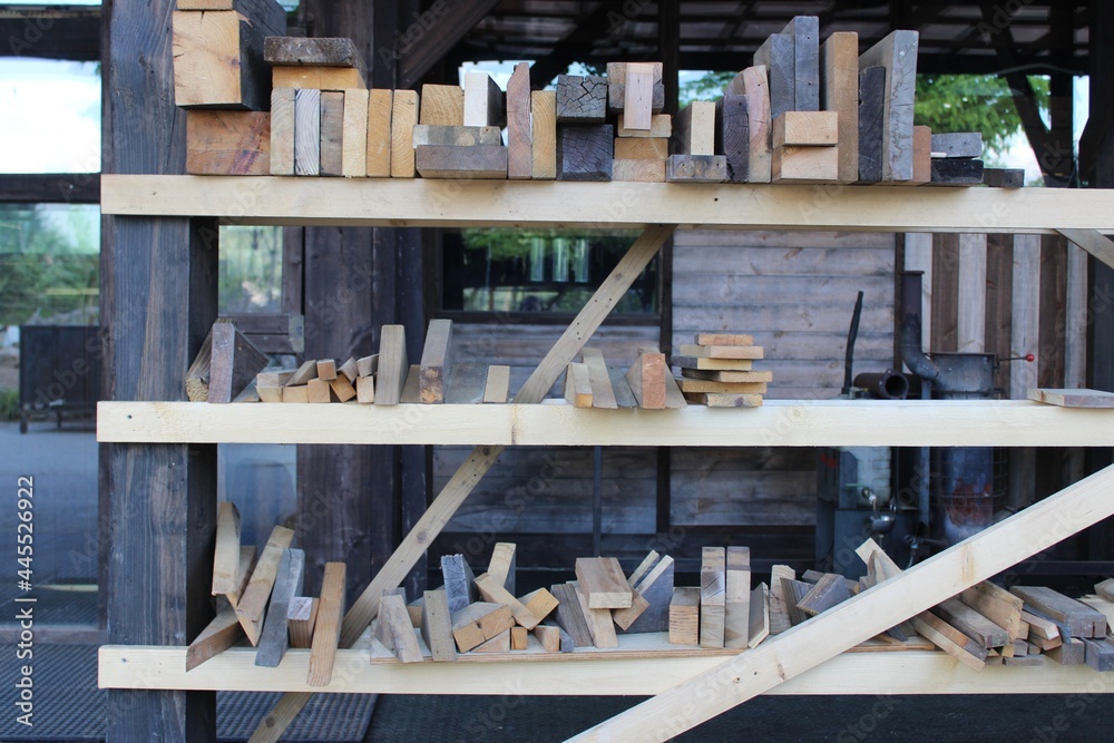 Planks of wood on carpenter's shelf