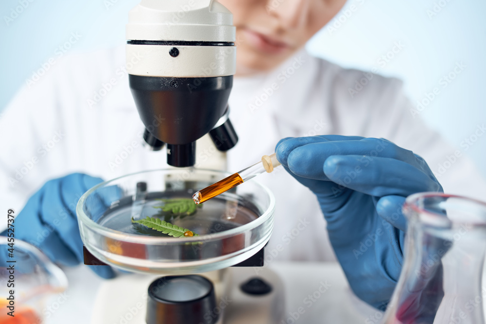 woman in laboratory adjusts microscope research analyzes technology woman in laboratory adjusts microscope research analyzes technology