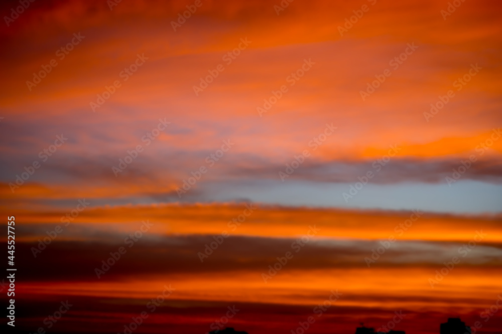 Blur image of Sunset sky with city in the shadow