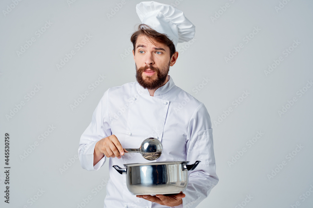 man preparing food with a saucepan in his hands chef professional kitchen work man preparing food with a saucepan in his hands chef professional kitchen work