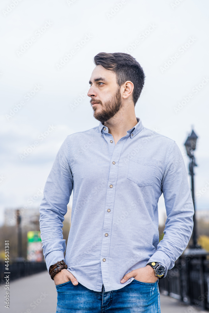 Portrait of a man businessman with a beard in a shirt while walking in the afternoon Portrait of a man businessman with a beard in a shirt while walking in the afternoon