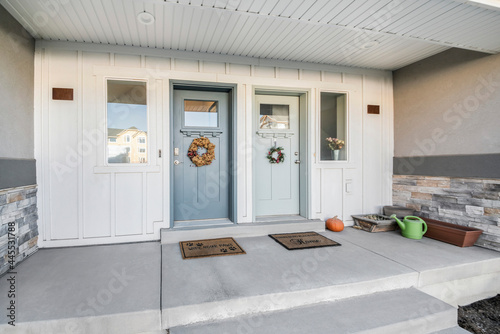 Duplex front doors with ornamental wreath decorations