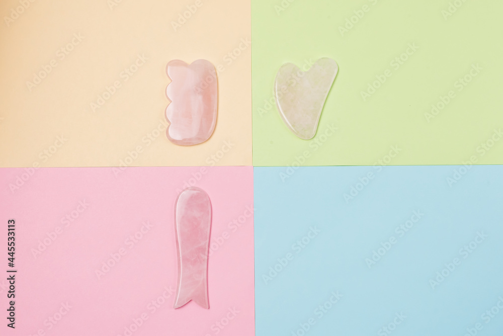 Gua Sha Massagers on Colored Background Pink jade stone for face and body Horizontal Flat lay Top view Copy Space Gua Sha Massagers on Colored Background Pink jade stone for face and body Horizontal Flat lay Top view Copy Space