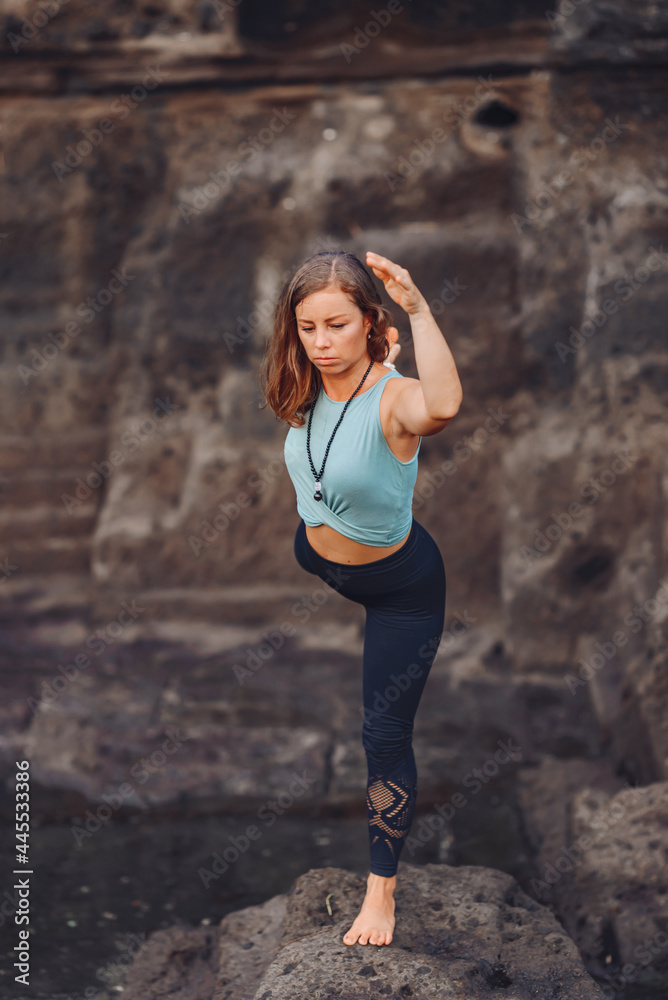 European girl doing yoga on the background of rocks.. European girl doing yoga on the background of rocks..