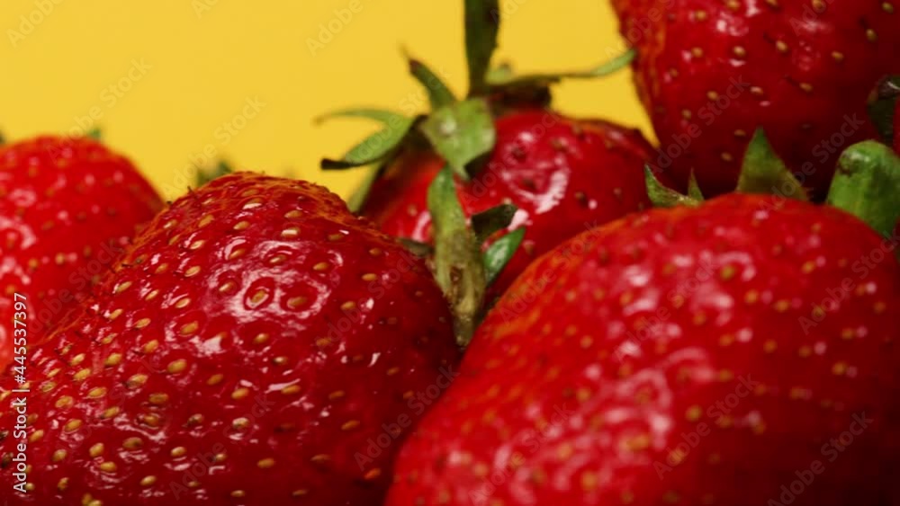 Tasty strawberry summer berries close up isolated on yellow background. Strawberry background. Healthy vegan food. Tasty strawberry summer berries close up isolated on yellow background. Strawberry background. Healthy vegan food.