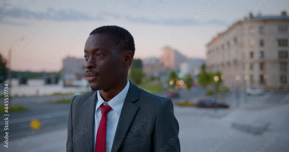 Medium shot of afro-american businessman looking away standing outdoors Medium shot of afro-american businessman looking away standing outdoors