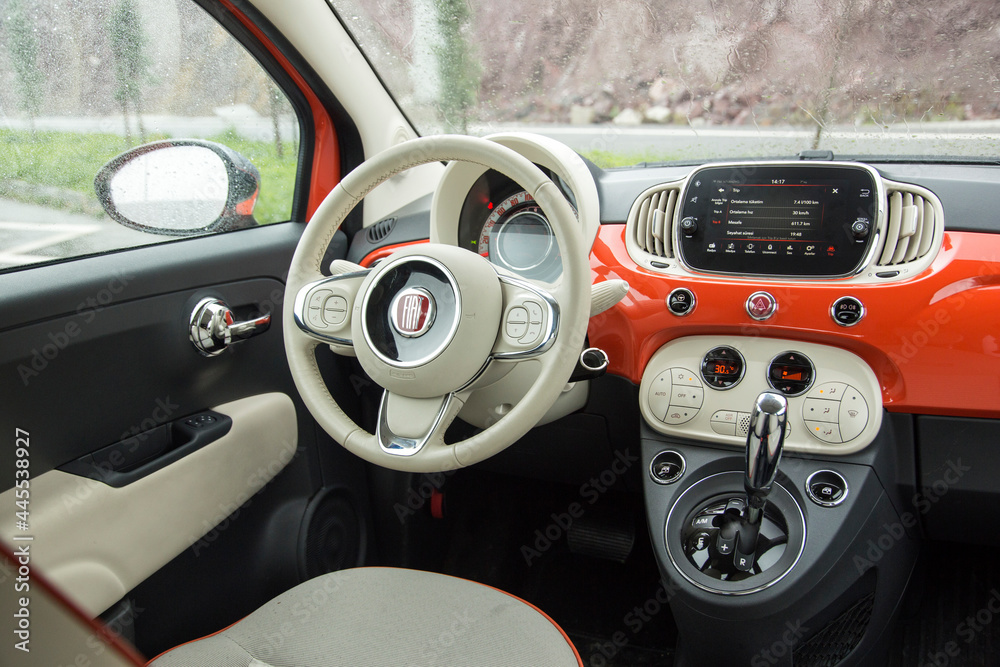 Fiat 500 C is convertible version of the Fiat 500 city car with a a  full-length sunroof. Fiat 500 C interior close up on driver's seat,  steering wheel and gauges. Stock Photo