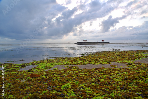 Sun rise at Sanur beach in Bali Indonesia during low tide.