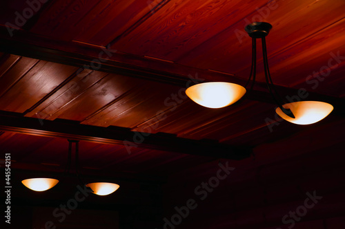 Lamps on the wooden ceiling in the room.