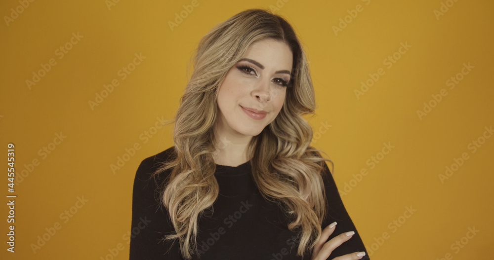 Young beautiful Caucasian blonde girl happily. Success and achievement concept. Cheerful pretty blonde woman on yellow background. Young beautiful Caucasian blonde girl happily. Success and achievement concept. Cheerful pretty blonde woman on yellow background.