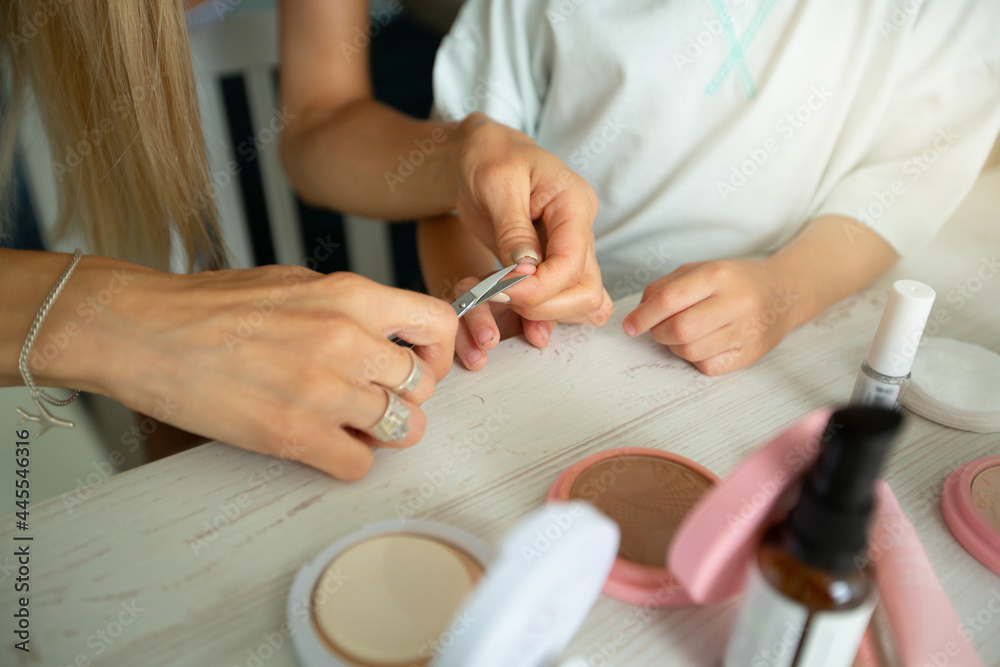 Young Mom Trims Her Little Daughter's Nails Young Mom Trims Her Little Daughter's Nails