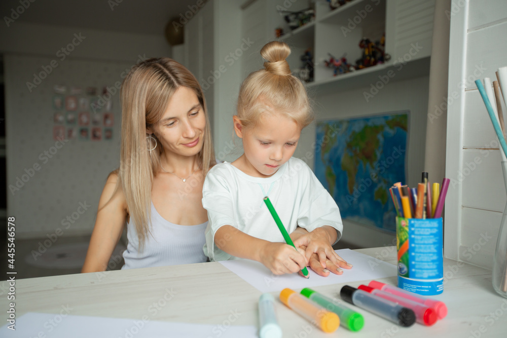 beautiful mother and daughter are drawing at home beautiful mother and daughter are drawing at home