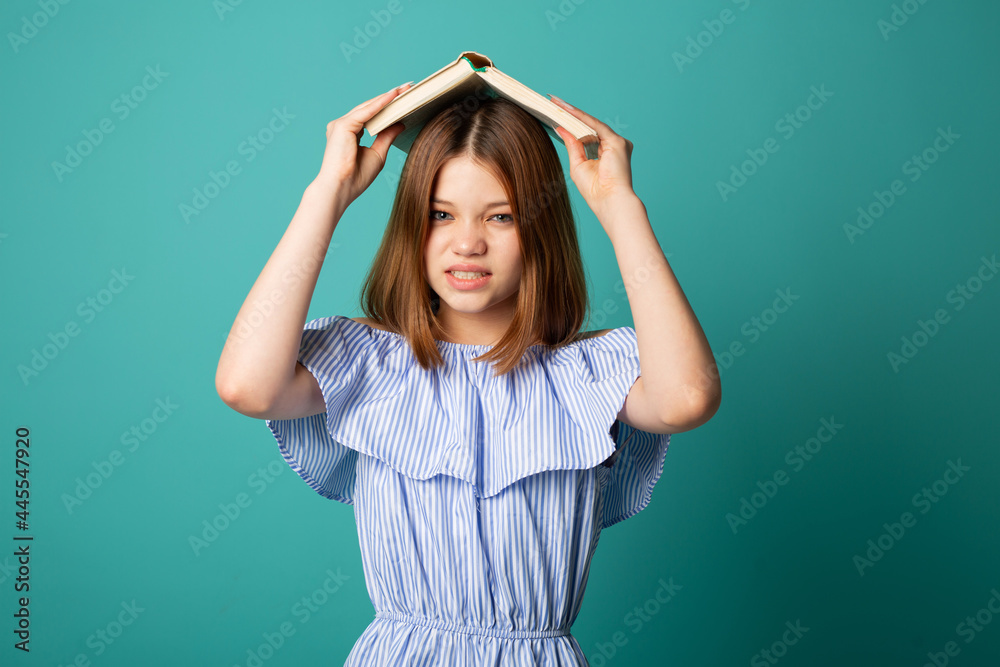 beautiful young emotional woman with a book on her head beautiful young emotional woman with a book on her head