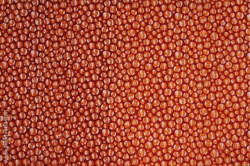 Fabric orange-red background in a grainy pattern