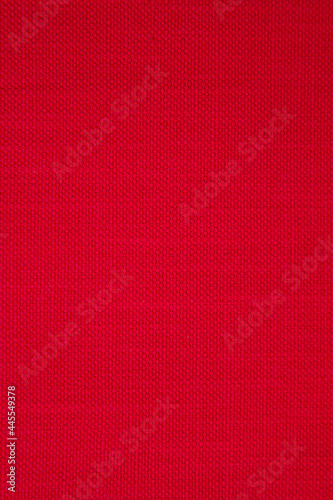 Red fabric background with a small round rib. Cotton fabric with a simple pattern